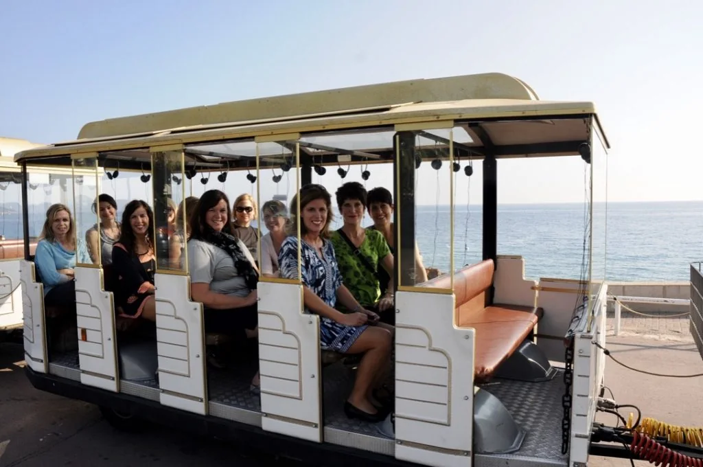 Traci traveling with a small group aboard a seaside trolley